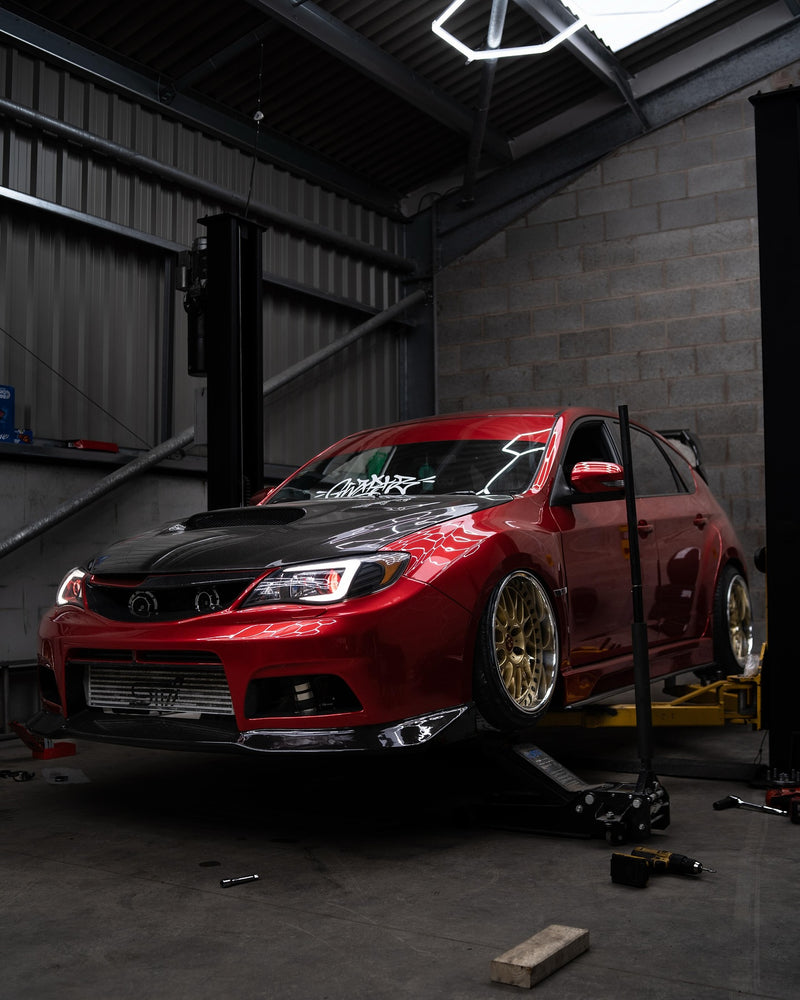 performance vehicle on lift during automotive servicing and upgrades